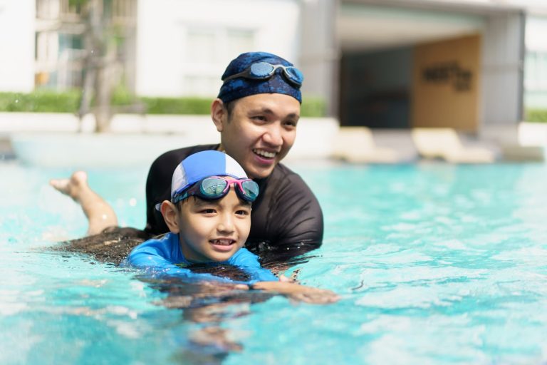 Father teaching his son to swim